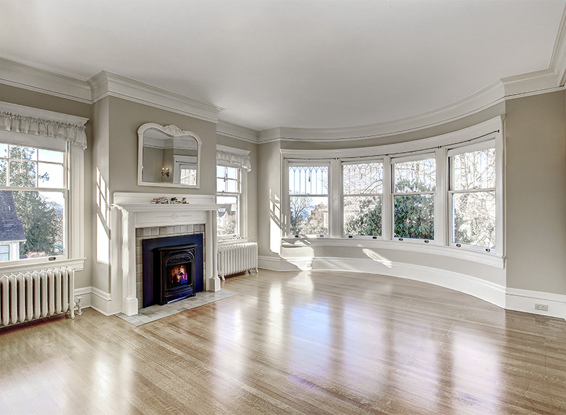 Elegant living room with fire place and different types of moulding