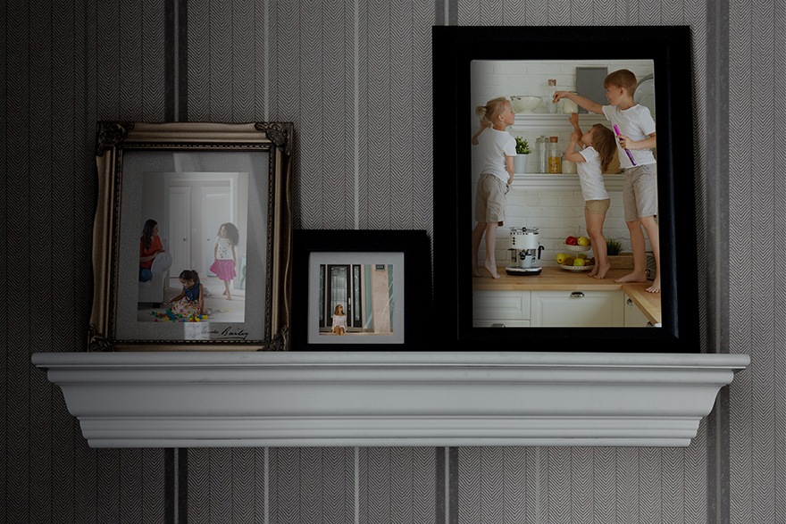 Modern Farmhouse mantel used as a shelf to hold 3 framed photos of children