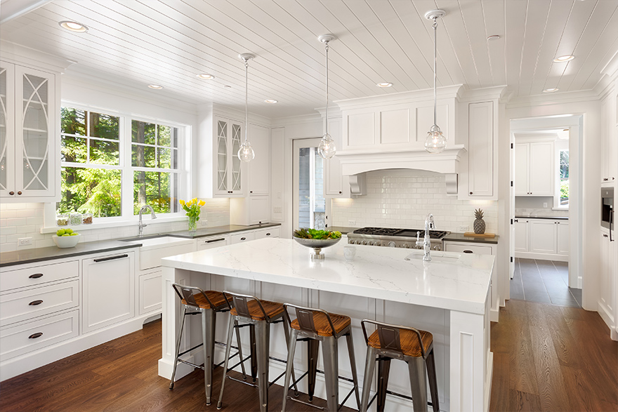 White kitchen with a white shiplap accent ceiling